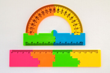 ruler and protractor multi-colored for drawing and geometry for schoolchildren on a white background - obrazy, fototapety, plakaty