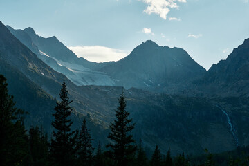 The peaks of the Altai Mountains in a blue haze in the Katunsky Reserve