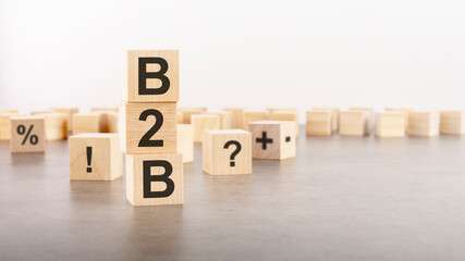 b2b text as a symbol on cube wooden blocks. many wooden blocks with symbol in the background