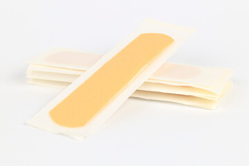 Adhesive plaster on a white background for first aid.