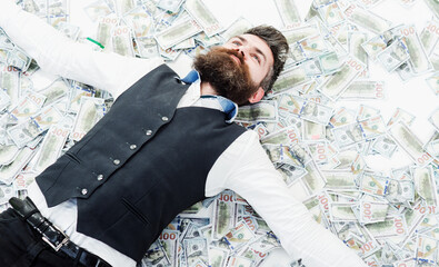 Businessman lying in many banknotes. Saving money. Business success. Rich millionaire, billionaire.