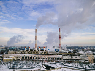 Factory smokestack emissions at cloud winter snow landscape, climate change and global warming for...