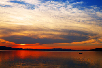 Obraz premium Beautiful orange sunset at Sempach Lake, Switzerland. Sunset sky image of tropical sunset. Summer vacation travel card or banner template 