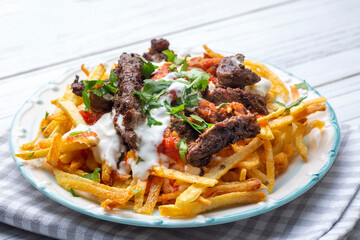 Turkish food; Cokertme Kebab - Beef meat kebab with yoghurt and french fries