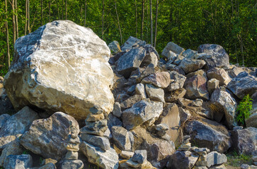 Mountain of stones in the forest in summer