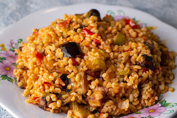 Traditional delicious Turkish food; Bulgur pilaf with eggplant and vegetables. (Turkish name; Patlicanli bulgur pilavi)