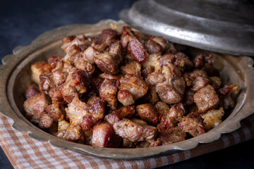 Muslims Traditional Sacrifice holiday food lamb, Turkish roasted meat in copper pot on table top. Turkish Kavurma. (Turkish name; Kurban kavurma)