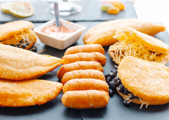 traditional Venezuelan food, fried arepas, empanadas and tequenos