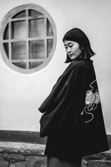 Portrait of sexy and young japanese girl with beautiful old traditional red kimono and black yukata...