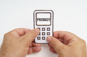 In the hands of a person is a cardboard model of a telephone with an inscription on the screen - Privacy