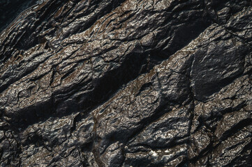 Textured background of wet rocky formation
