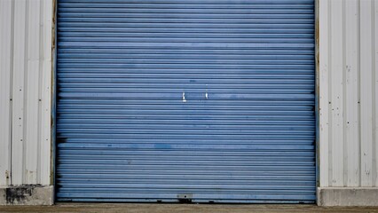 blue industrial metal shutter door as background