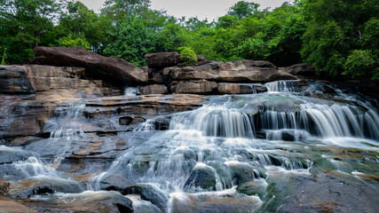 A waterfall in the middle of a natural forest