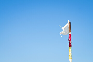 white flag signaling on a beach