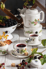 fruit tea with ripe blackberries, vintage still life with beautiful retro set 