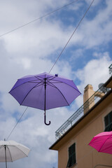 Purple umbrella suspended in the sky