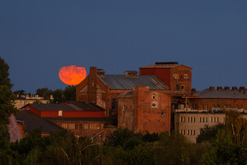 Supermoon of August over the old sugar factory in Pruszcz Gdanski. Poland