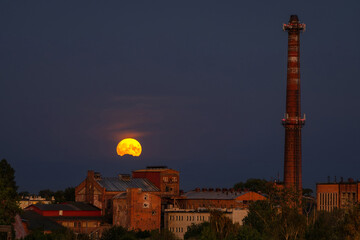 Supermoon of August over the old sugar factory in Pruszcz Gdanski. Poland