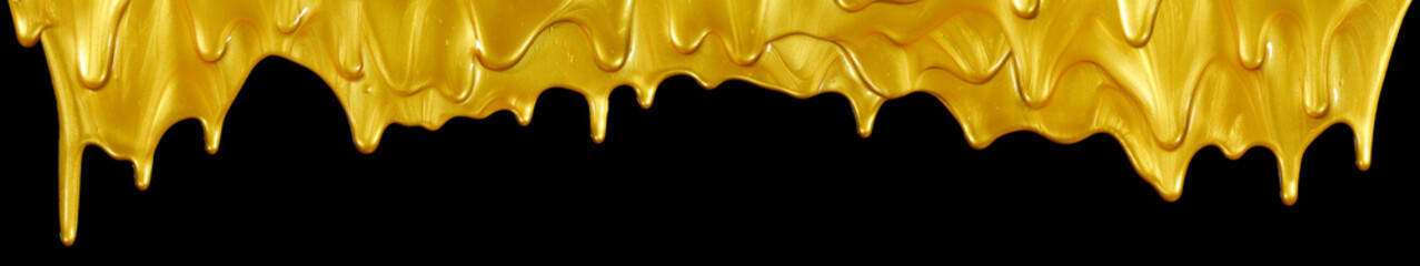 Top border of glittering shiny metallic gold paint flowing and dripping downward. Isolated on black.