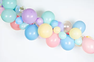 Foto op Canvas A close up image of a soft pastel balloon garland against a white background © Ursula Page