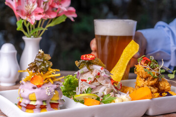 Seafood trio, ceviche with fish crackling and seafood cause, is a typical dish of Peru.