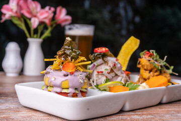 Seafood trio, ceviche with fish crackling and seafood cause, is a typical dish of Peru.