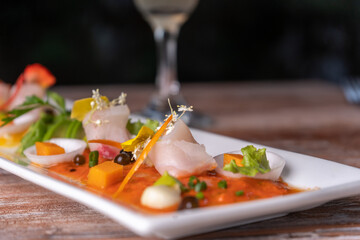 Fish tiradito in different peppers, typical dish of Peru..
