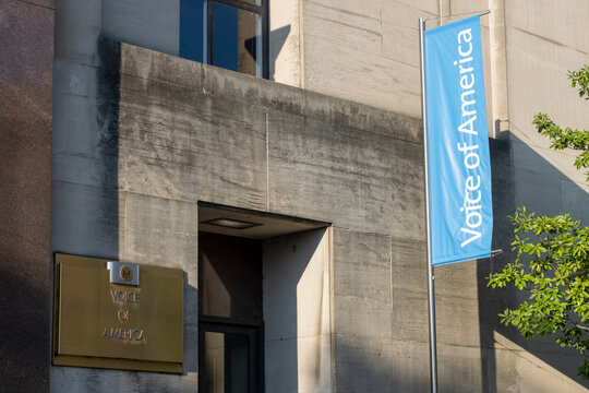 Washington, DC, USA - June 24, 2022: The Voice of American (VOA) signs are seen at the entrance to the VOA headquarters in the Wilbur J. Cohen Building in Washington, DC.