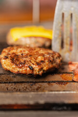 Close up view of a hamburger cooked on a grill