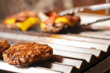 Grilled hamburgers in a barbecue with some cheeseburgers with bacon