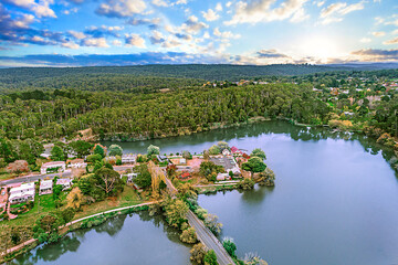 Daylesford Victoria's Spa Country. View of a lake with a house and wood forest in distance. View of...
