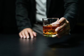Closeup businessmen holding a glass of whiskey