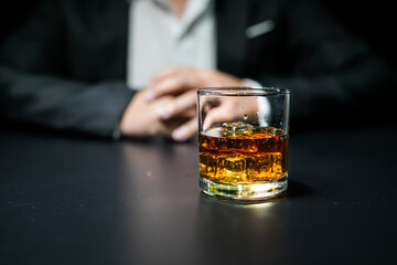 Closeup businessmen holding a glass of whiskey