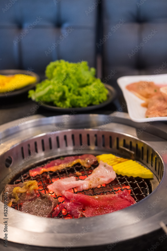 Wall mural Raw beef slice on steel wire mesh for barbecue Japanese style.