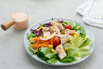 Green salad from green leaves mix vegetables, potatoes and roasted chicken with mayonnaise sauce. 