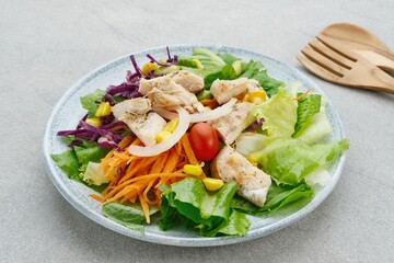 Green salad from green leaves mix vegetables, potatoes and roasted chicken with mayonnaise sauce. 