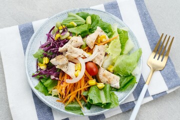 Green salad from green leaves mix vegetables, potatoes and roasted chicken with mayonnaise sauce. 