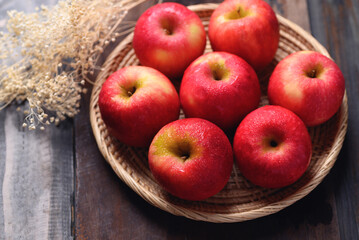 Red apple fruit in basket on wooden background, Healthy fruit