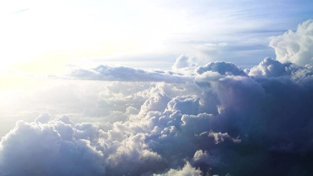 beautiful fluffy clouds in a sky. travelling by air. Airplane flight on sunset