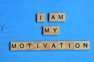 I am my motivation text on wooden square, motivation and health quotes