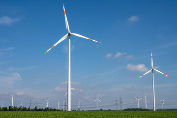 Wind turbines with power lines in the back seen in Germany