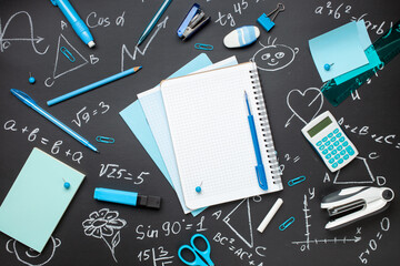 Blue stationery on black background. School stationery supplies. Workplace organization. Concept back to school.