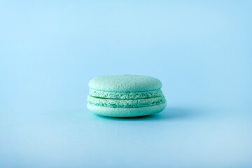 Colorful french one macarons cookie (macaroons) on blue background. Dessert, vegetarian sweets close up