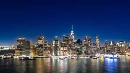 Wide angle view of Manhattan at night from Brooklyn Bridge Park 