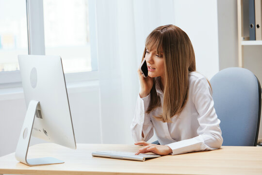 Serious adorable blonde businesswoman worker make difficult decision talking with client in call in light modern office. Nervous employee work on computer online in support service. Copy space