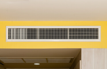Air conditioning wall mounted ventilation system on ceiling in the white hotel room,  Air conditioning grille or hole or air drainage. - obrazy, fototapety, plakaty