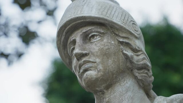 Close up of the head of a male statue in the park 