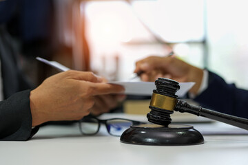 judge on wooden table And experienced lawyers meet with clients and give advice behind the scenes. legal services legal consulting concept