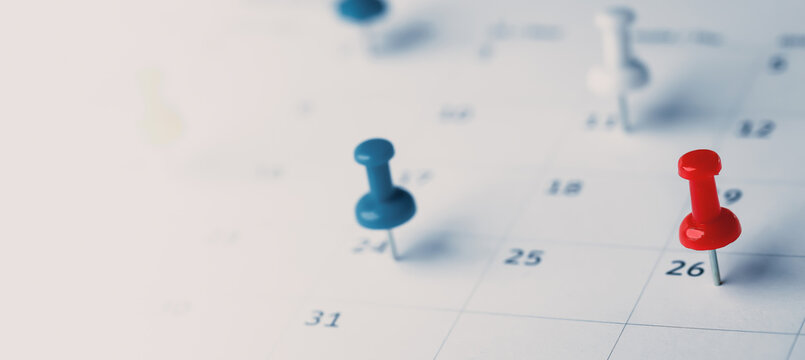 Embroidered red pins on a calendar event Planner calendar,clock to set timetable organize schedule,planning for business meeting or travel planning concept.