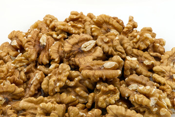 Pile of walnuts isolated on white background. Food texture concept